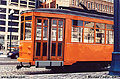 This picture of an orange trolley car was taken out the window of my car at one of the many stop we made while inching our way along the Embarcadero. San Francisco, CA. 'Minolta X700 35mm SLR' (Click for larger view)